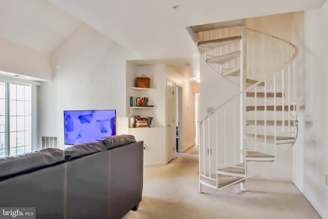 carpeted living room with vaulted ceiling