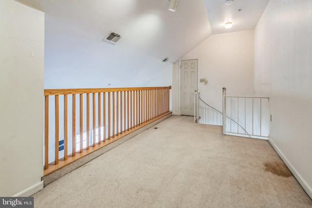 bonus room featuring light colored carpet and lofted ceiling