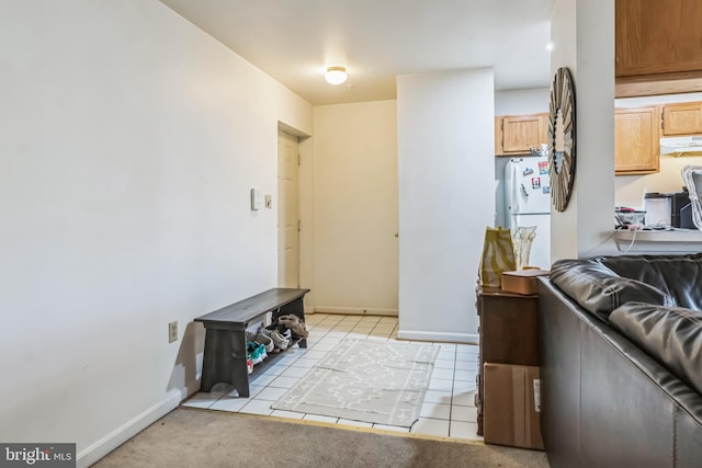 interior space featuring light tile patterned floors, extractor fan, and white refrigerator