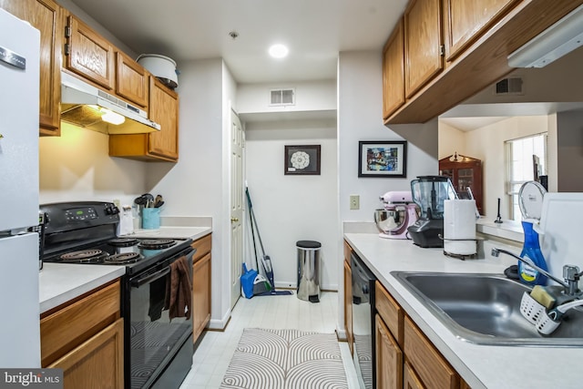 kitchen featuring black appliances, light tile patterned flooring, and sink