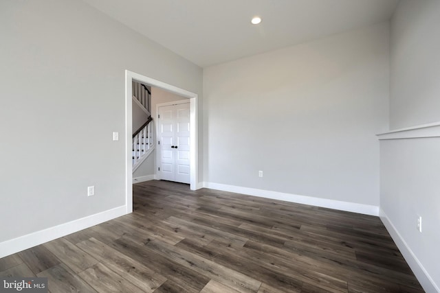 unfurnished room featuring dark wood-type flooring