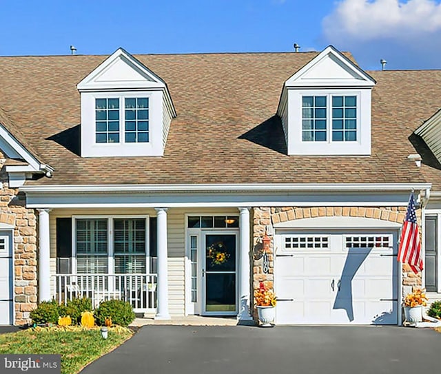 view of front facade with a porch and a garage