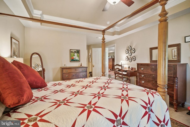 carpeted bedroom with a tray ceiling, ceiling fan, and ornamental molding