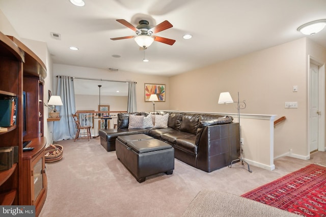 carpeted living room with ceiling fan