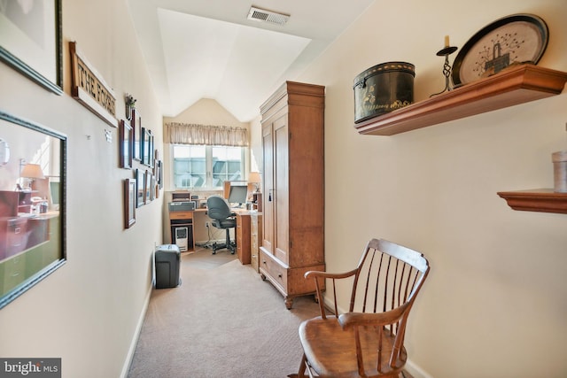 hall with light colored carpet and vaulted ceiling