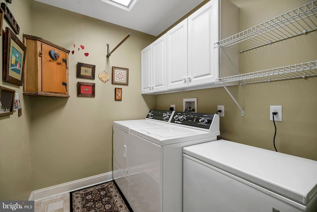 laundry room featuring washer and dryer and cabinets