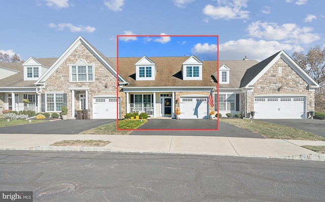 view of front of home with covered porch and a garage