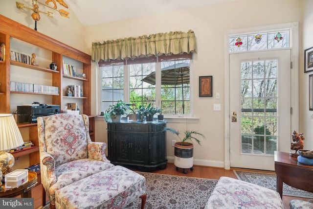 living area featuring hardwood / wood-style floors and vaulted ceiling