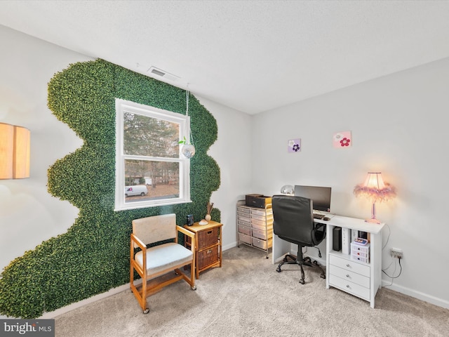 office area featuring baseboards, visible vents, and light colored carpet