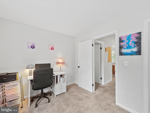 home office with light colored carpet and baseboards