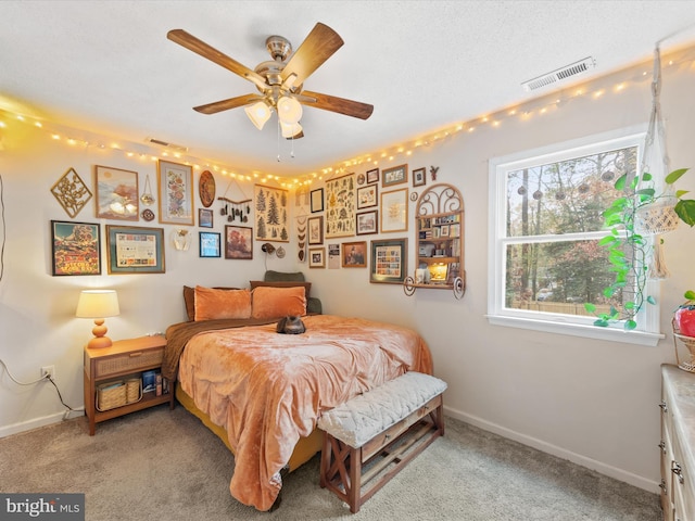 bedroom featuring visible vents, light carpet, and baseboards