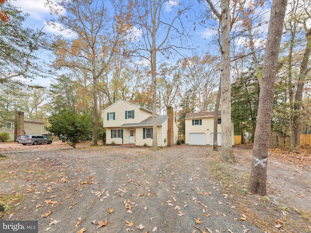 view of front of property featuring driveway and a chimney