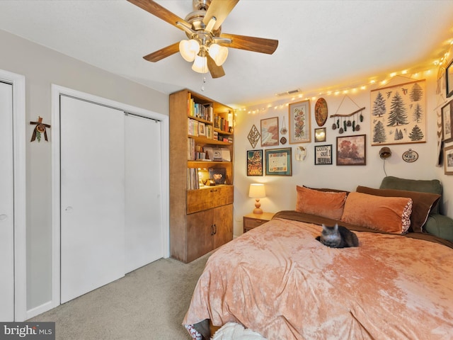 bedroom featuring ceiling fan, visible vents, and light colored carpet