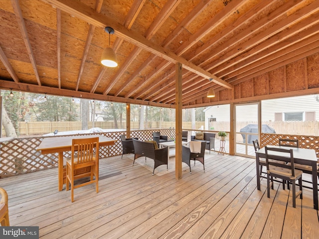 wooden deck featuring outdoor dining area and a fenced backyard