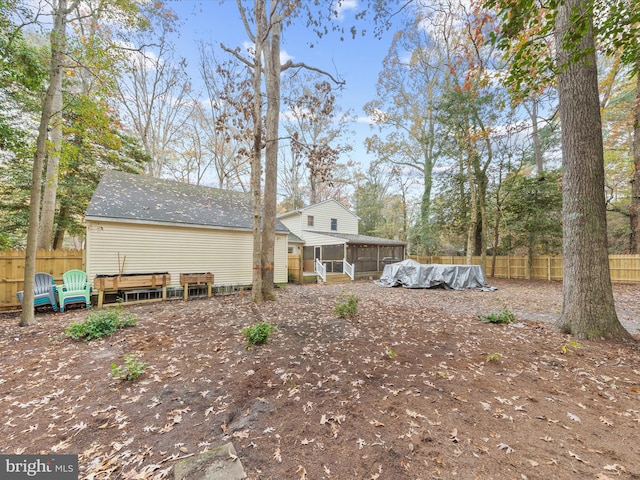 back of house with fence private yard and a sunroom