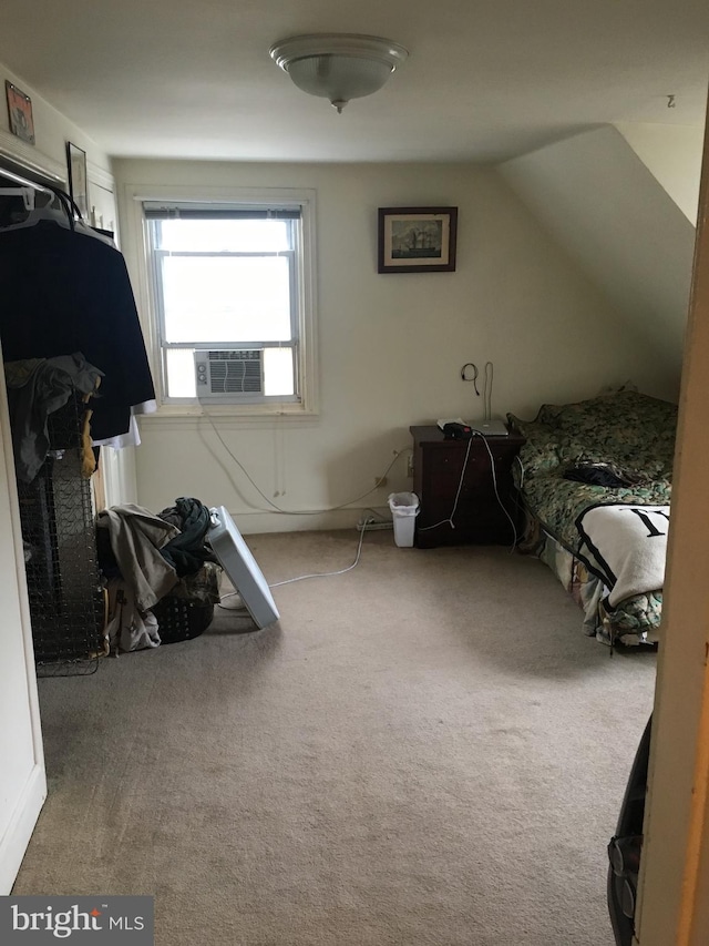 carpeted bedroom with vaulted ceiling and cooling unit