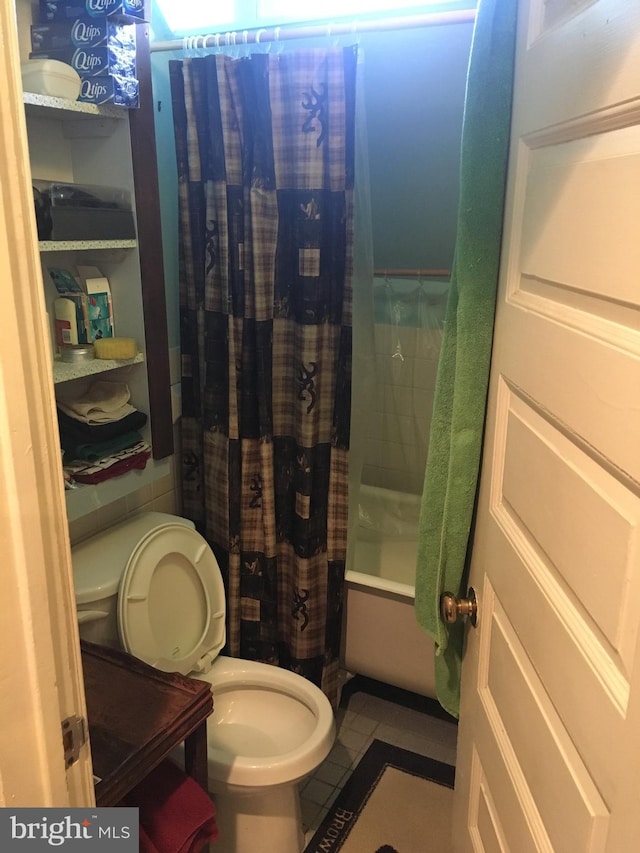 bathroom with shower / bathtub combination with curtain and toilet