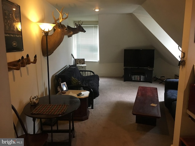 sitting room featuring carpet flooring and lofted ceiling with skylight