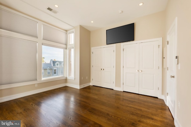 unfurnished bedroom with dark hardwood / wood-style floors