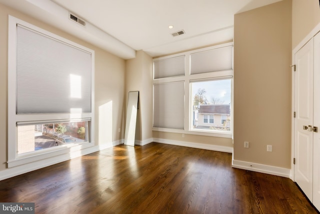 interior space featuring dark wood-type flooring and a healthy amount of sunlight