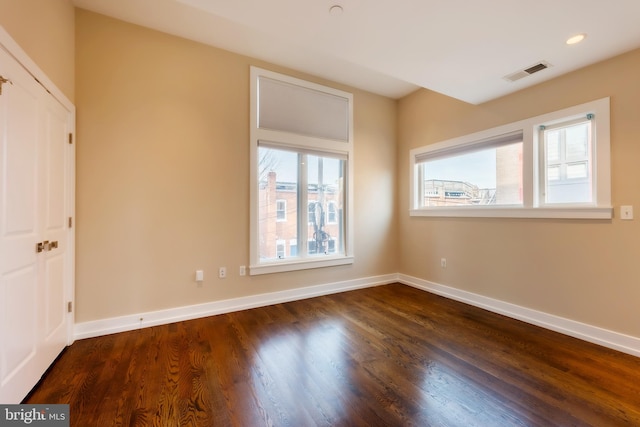 unfurnished room featuring dark hardwood / wood-style floors