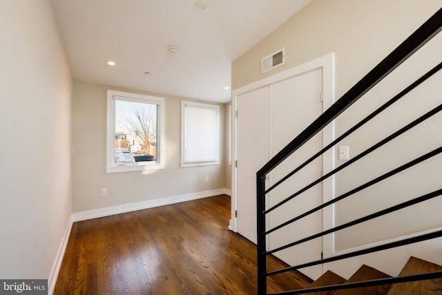 stairs featuring hardwood / wood-style floors and lofted ceiling