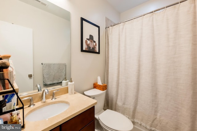 bathroom featuring vanity, toilet, and curtained shower