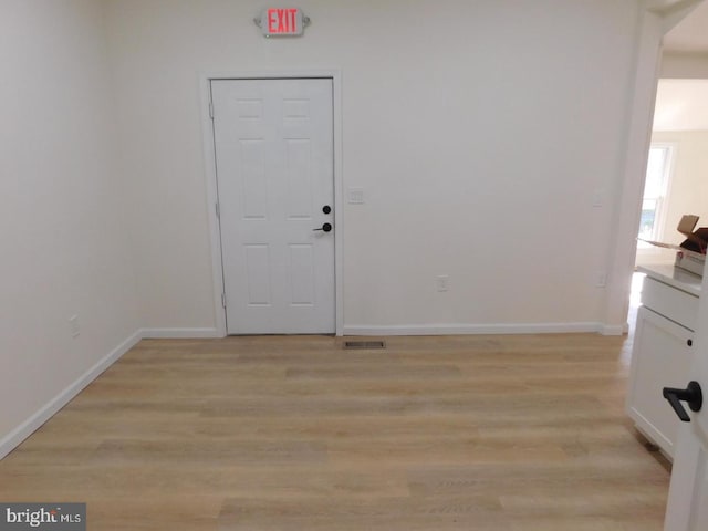 spare room with light wood-type flooring