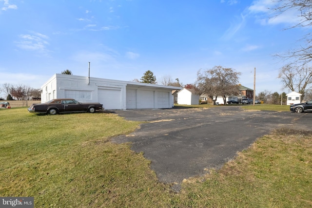 exterior space featuring a garage and a front lawn