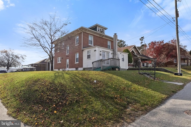 view of side of home featuring a lawn