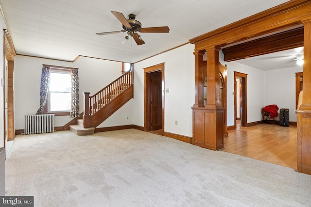 unfurnished living room with ceiling fan, crown molding, radiator, and light hardwood / wood-style flooring