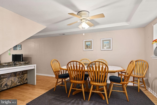 213 E Hand Ave, Wildwood, NJ 08260 - dining room featuring wood finished floors, baseboards, ceiling fan, and a raised ceiling