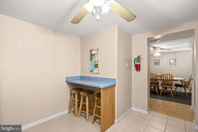 213 E Hand Ave, Wildwood, NJ 08260 - bar featuring ceiling fan, baseboards, and light tile patterned floors