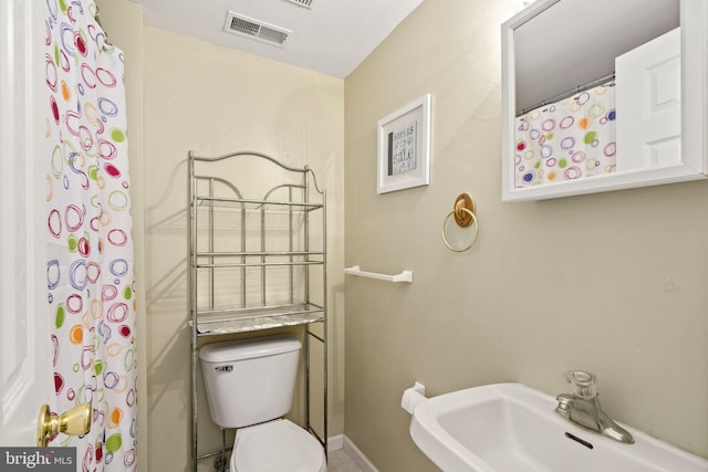 213 E Hand Ave, Wildwood, NJ 08260 - bathroom with a sink, toilet, and baseboards