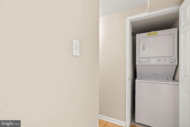 213 E Hand Ave, Wildwood, NJ 08260 - laundry room featuring stacked washer and clothes dryer, light wood finished floors, and baseboards
