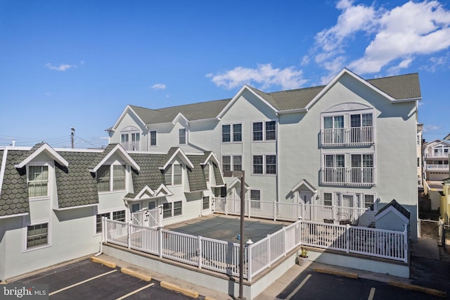 213 E Hand Ave, Wildwood, NJ 08260 - back of house with stucco siding and uncovered parking
