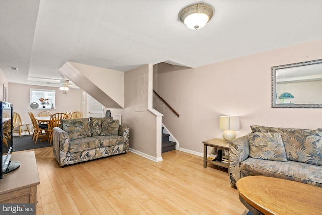 213 E Hand Ave, Wildwood, NJ 08260 - living room featuring stairs, light wood-style flooring, baseboards, and a ceiling fan