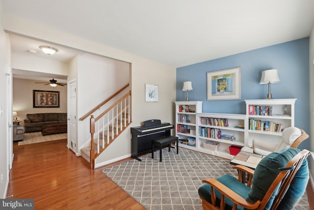 living area with ceiling fan and wood-type flooring