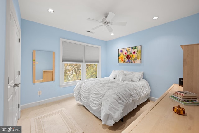 bedroom featuring ceiling fan and light carpet