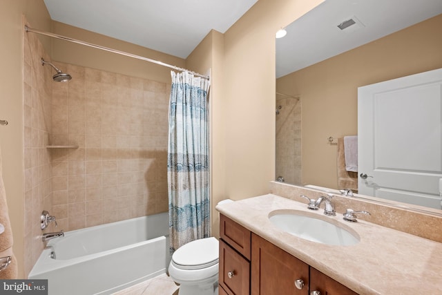 full bathroom with tile patterned floors, shower / bath combo, toilet, and vanity