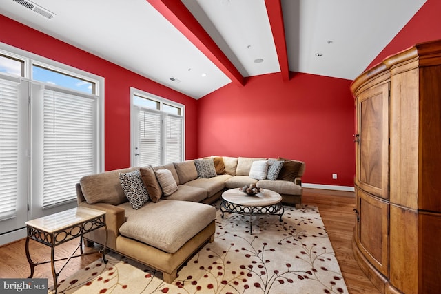 living room featuring hardwood / wood-style floors and lofted ceiling with beams