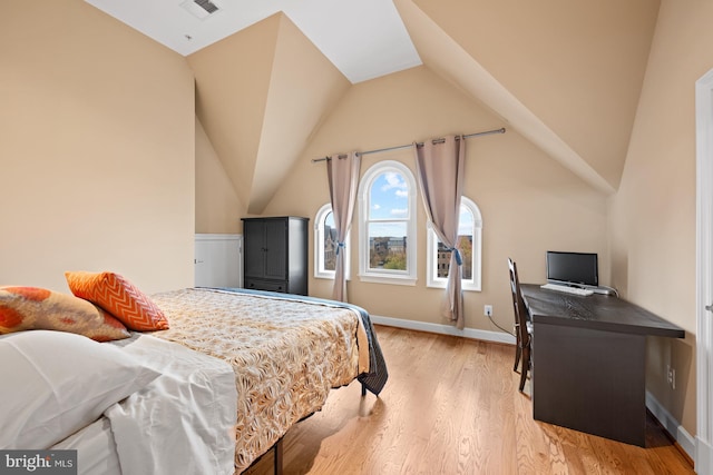 bedroom featuring light hardwood / wood-style floors and lofted ceiling