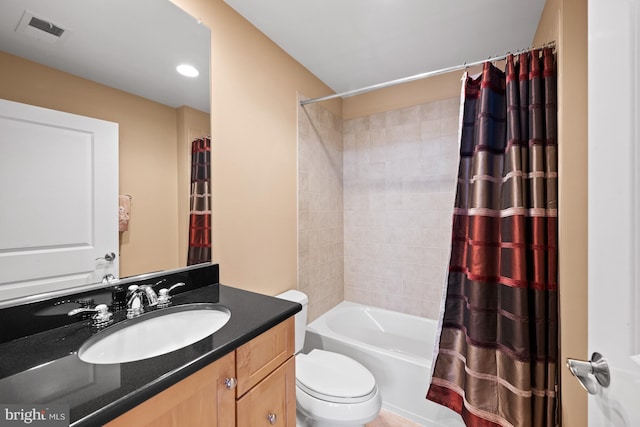 full bathroom featuring vanity, toilet, and shower / tub combo with curtain