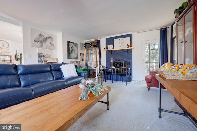 living room with light colored carpet and a brick fireplace