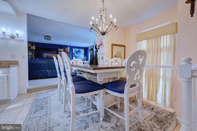 dining room featuring light tile patterned flooring and an inviting chandelier