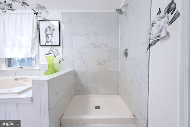 bathroom with a tile shower