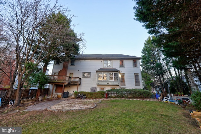 rear view of property featuring a yard