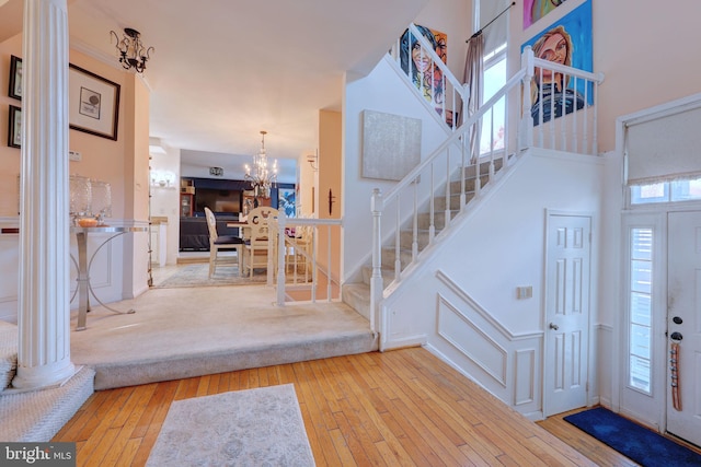 foyer featuring light hardwood / wood-style floors, a wealth of natural light, and a chandelier