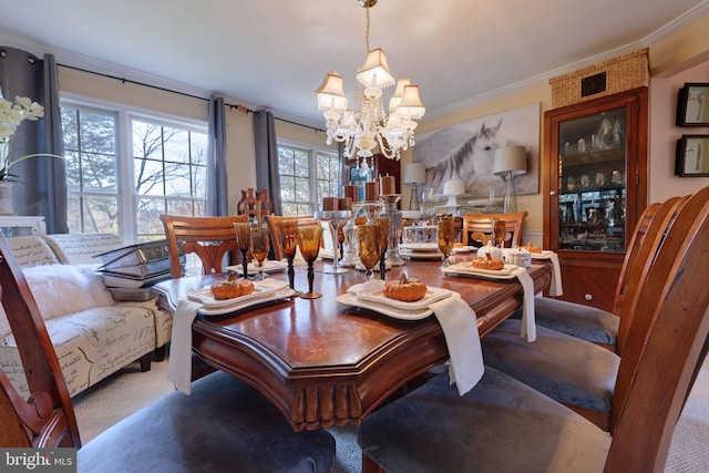 dining room featuring ornamental molding and a notable chandelier