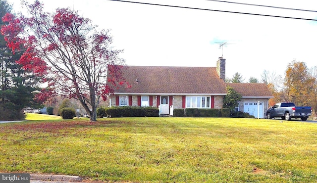 view of front facade with a garage and a front lawn